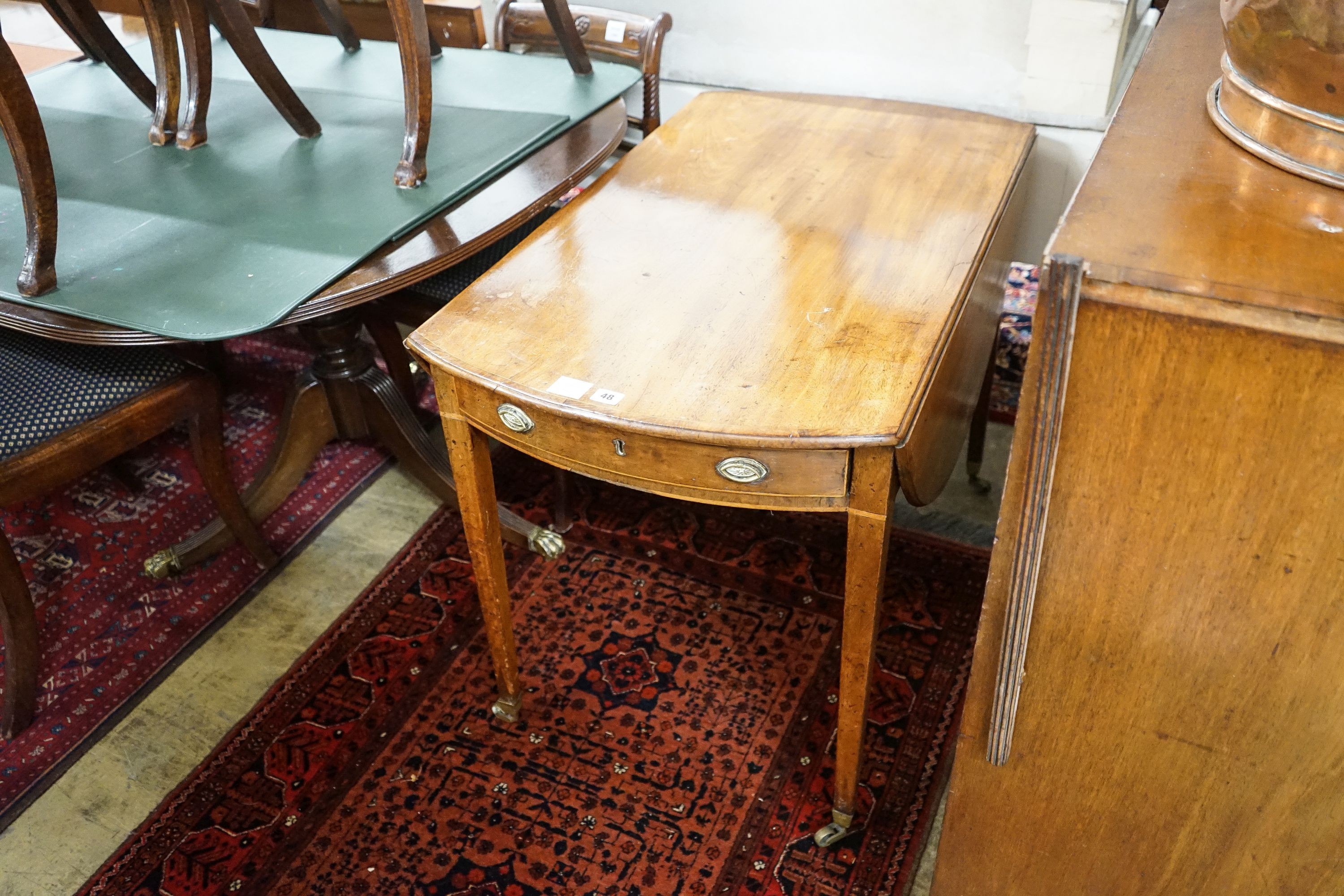 A George III banded mahogany oval topped Pembroke table, width 59cm, depth 102cm, height 71cm